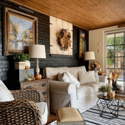 A room with a white couch and rug with a black brick wall., by vaughnhillhome.